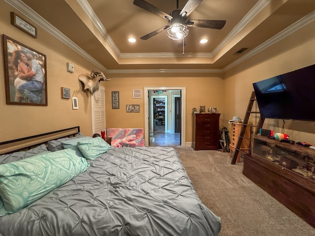 bedroom with a raised ceiling, ornamental molding, and carpet flooring