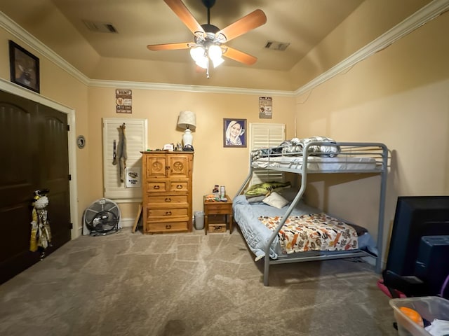 bedroom featuring ceiling fan, ornamental molding, a raised ceiling, and carpet