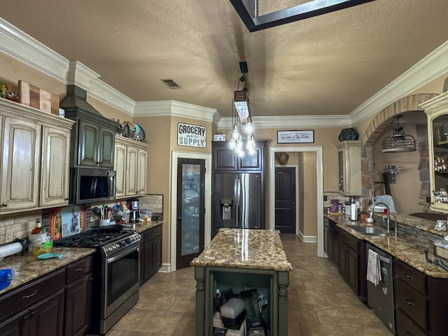 kitchen with sink, dark brown cabinets, stainless steel appliances, and a kitchen island