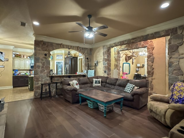 living room with crown molding, ceiling fan, and hardwood / wood-style flooring