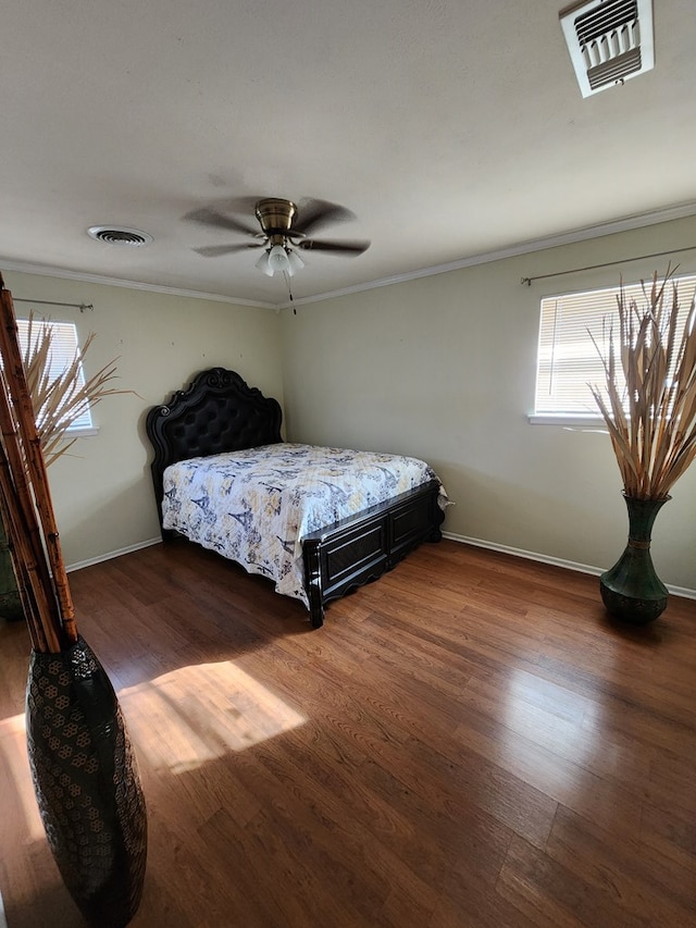 bedroom with ceiling fan, crown molding, and dark hardwood / wood-style floors