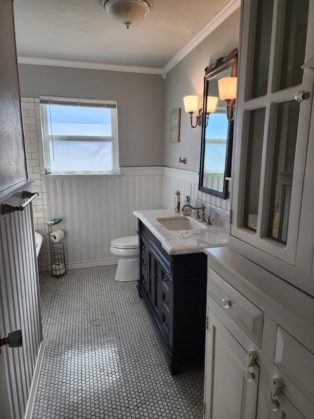 bathroom with vanity, toilet, and crown molding