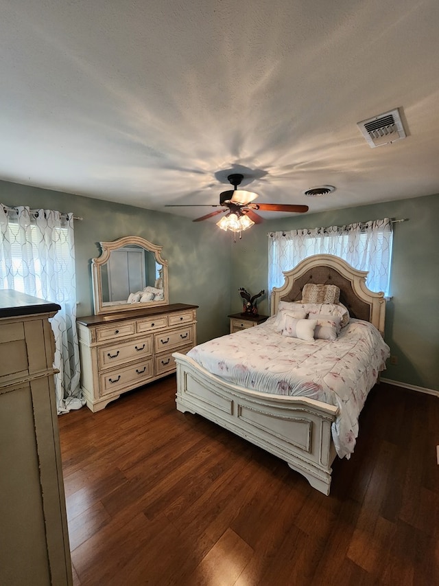 bedroom featuring ceiling fan and dark hardwood / wood-style flooring