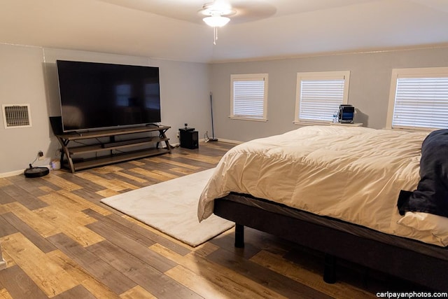 bedroom with hardwood / wood-style floors and ceiling fan