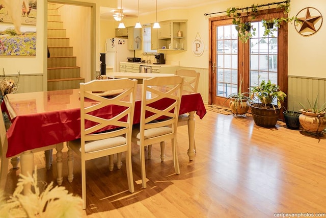 dining space featuring ornamental molding and light hardwood / wood-style flooring