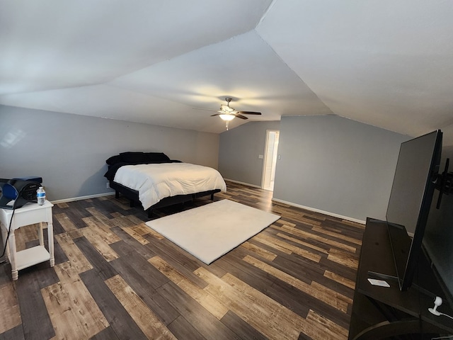 bedroom featuring dark hardwood / wood-style floors, vaulted ceiling, and ceiling fan