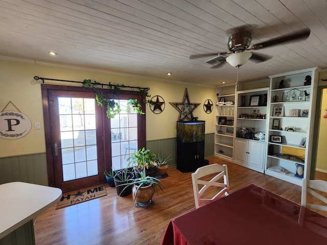 interior space featuring wood-type flooring, ornamental molding, wooden ceiling, and ceiling fan