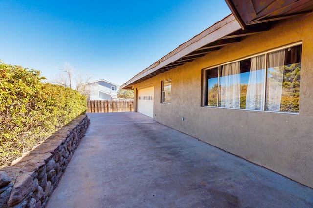 view of side of home featuring a garage