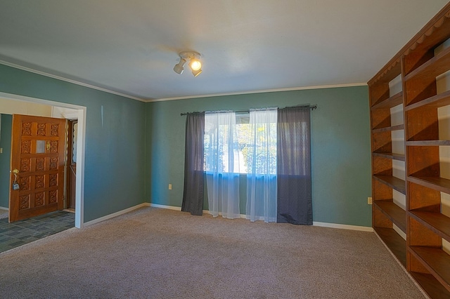 unfurnished room featuring crown molding and carpet floors