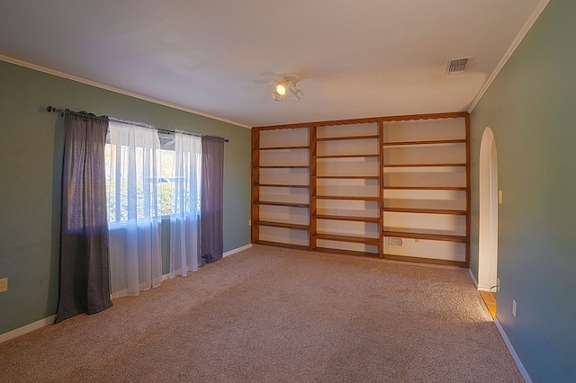 spare room with crown molding and light carpet