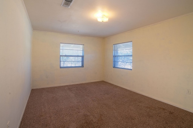 unfurnished room with carpet flooring, ornamental molding, and a healthy amount of sunlight