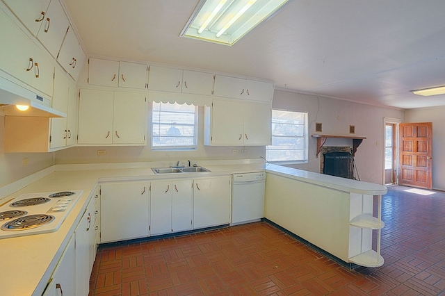 kitchen with kitchen peninsula, sink, white cabinets, and white appliances