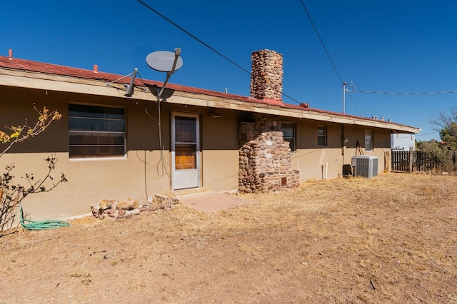 rear view of house featuring central AC