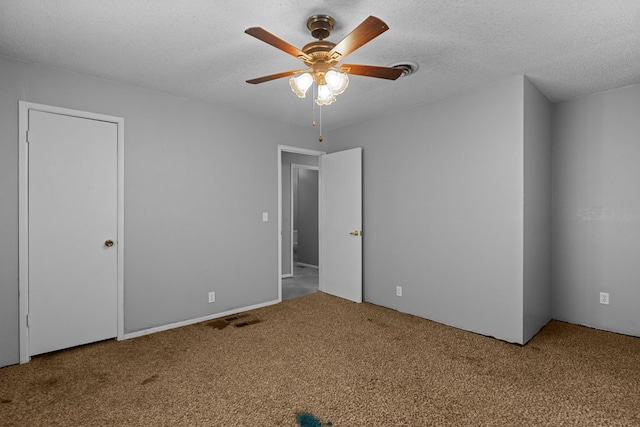 interior space with a textured ceiling, ceiling fan, and light carpet