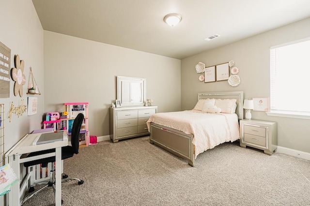 bedroom with light colored carpet, visible vents, and baseboards