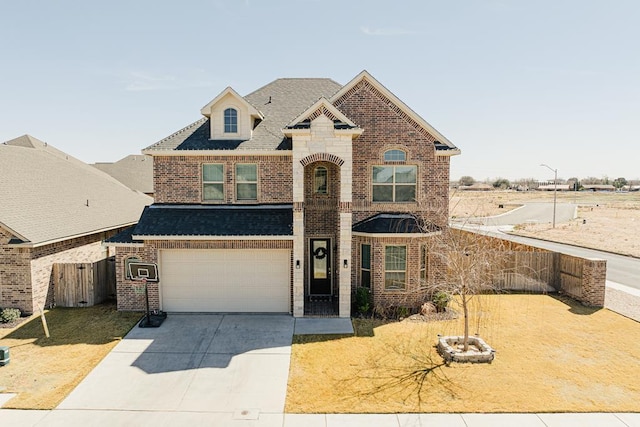 view of front of home featuring a garage, concrete driveway, brick siding, and fence