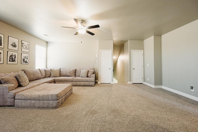 carpeted living room featuring ceiling fan, visible vents, and baseboards