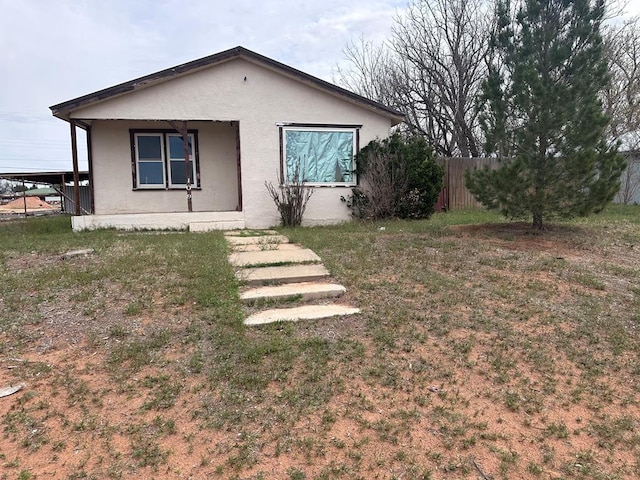 exterior space featuring a front lawn and a carport