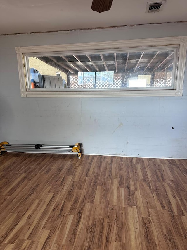 unfurnished room featuring hardwood / wood-style flooring and a wealth of natural light