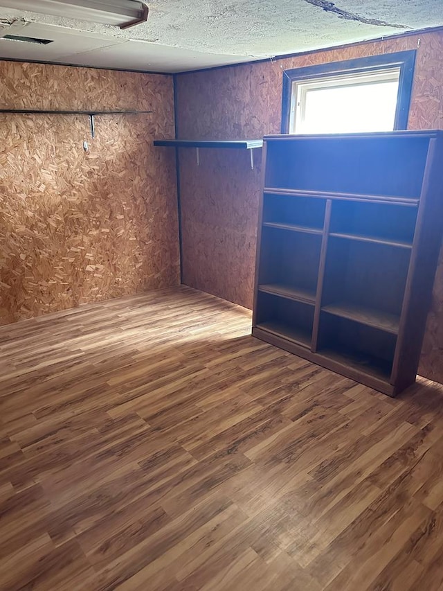 empty room with dark wood-type flooring and a textured ceiling