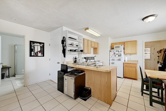 kitchen featuring tile countertops, white appliances, kitchen peninsula, and light tile patterned floors