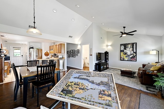 dining space featuring ceiling fan, high vaulted ceiling, and wood-type flooring