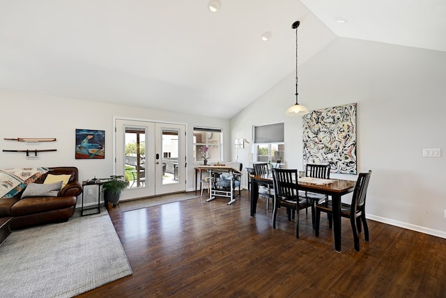 dining space with french doors, dark hardwood / wood-style floors, and high vaulted ceiling