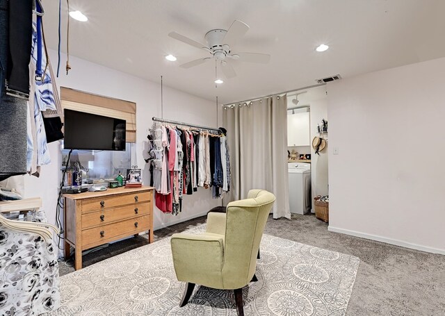 walk in closet featuring light carpet, ceiling fan, and washer / dryer