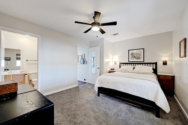 carpeted bedroom featuring connected bathroom, ceiling fan, and sink