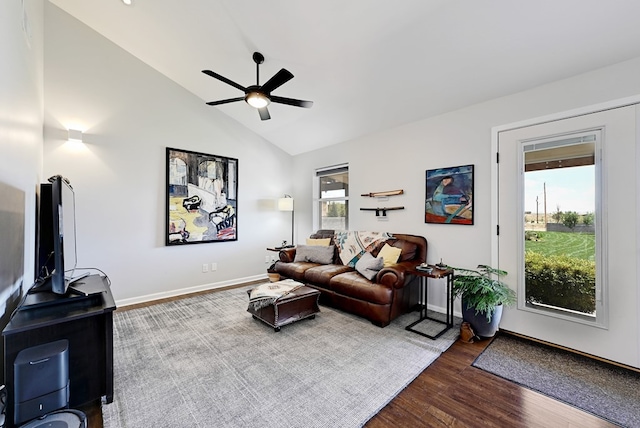 living room featuring ceiling fan, plenty of natural light, wood-type flooring, and lofted ceiling