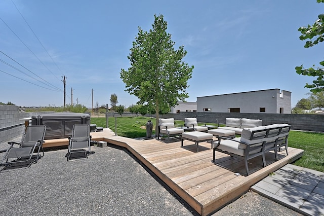 wooden terrace featuring an outdoor living space, a hot tub, and a lawn