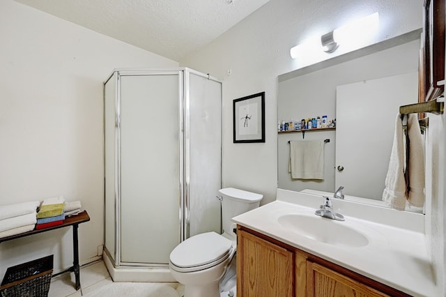 bathroom featuring vanity, tile patterned floors, toilet, a textured ceiling, and a shower with shower door