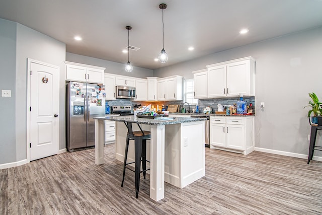 kitchen featuring white cabinetry, appliances with stainless steel finishes, and a center island