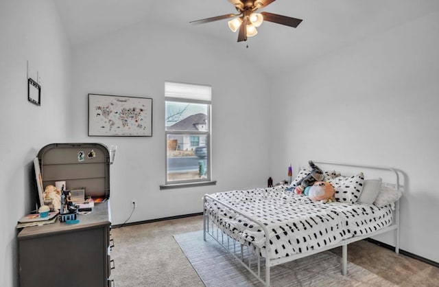 bedroom featuring lofted ceiling, baseboards, a ceiling fan, and light colored carpet