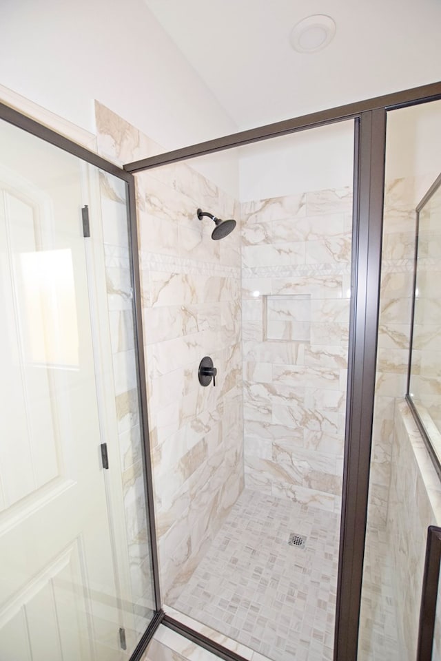 bathroom featuring a shower with shower door