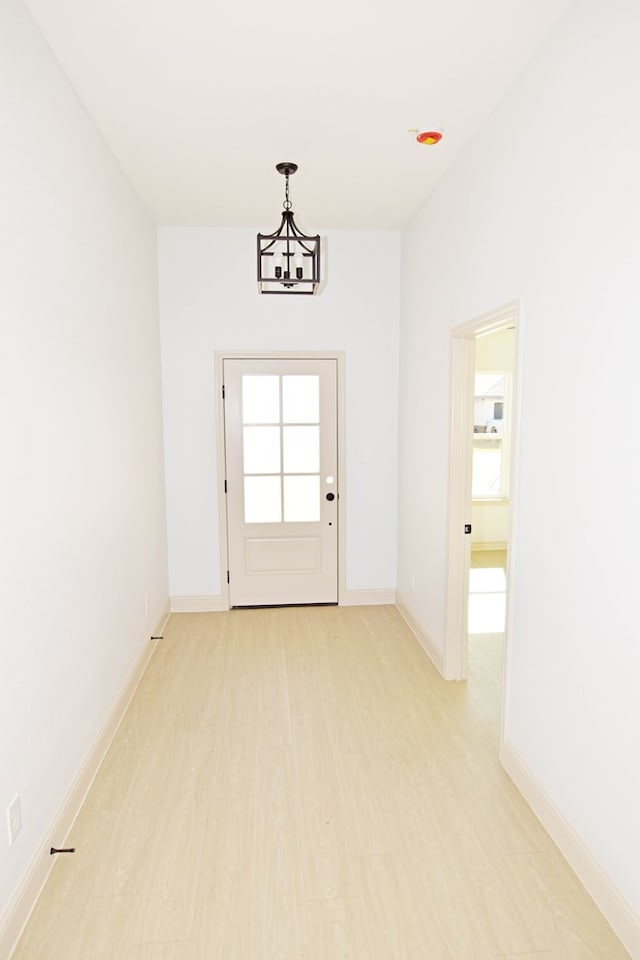 entryway with a chandelier and light hardwood / wood-style flooring