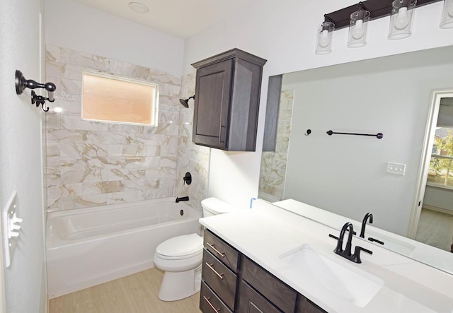 full bathroom with hardwood / wood-style flooring, vanity, toilet, and tiled shower / bath