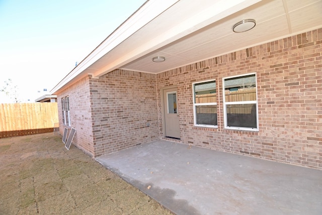 view of exterior entry featuring a patio