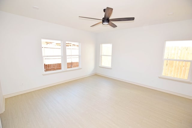 spare room featuring ceiling fan and light wood-type flooring