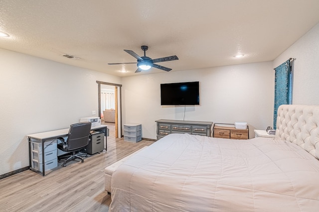 bedroom featuring ceiling fan, a textured ceiling, and light wood-type flooring