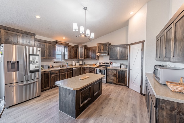 kitchen with light hardwood / wood-style flooring, appliances with stainless steel finishes, hanging light fixtures, a center island, and dark brown cabinetry