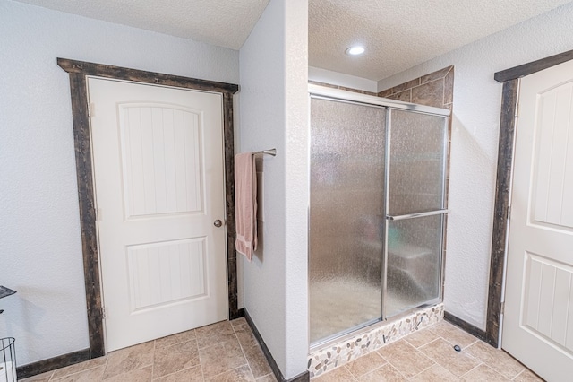 bathroom featuring walk in shower and a textured ceiling