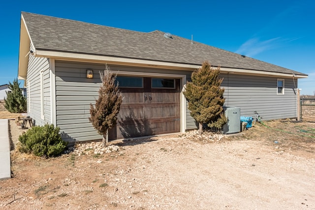 back of property featuring a garage