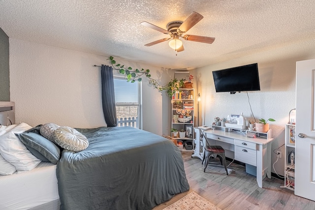 bedroom featuring wood-type flooring, ceiling fan, and a textured ceiling