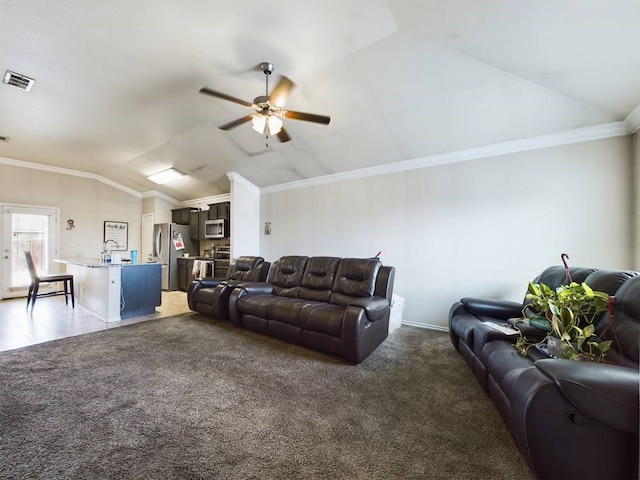 living room featuring lofted ceiling, dark carpet, ornamental molding, and ceiling fan