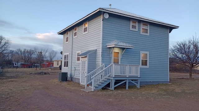 rear view of property with central AC