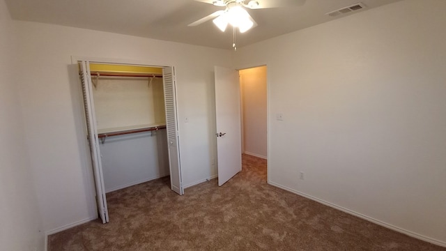 unfurnished bedroom featuring ceiling fan, a closet, and carpet