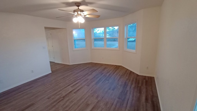 spare room featuring ceiling fan and dark hardwood / wood-style flooring