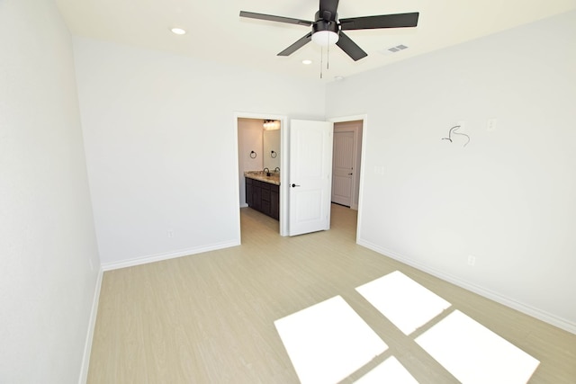 unfurnished bedroom featuring light hardwood / wood-style flooring, ceiling fan, and ensuite bathroom