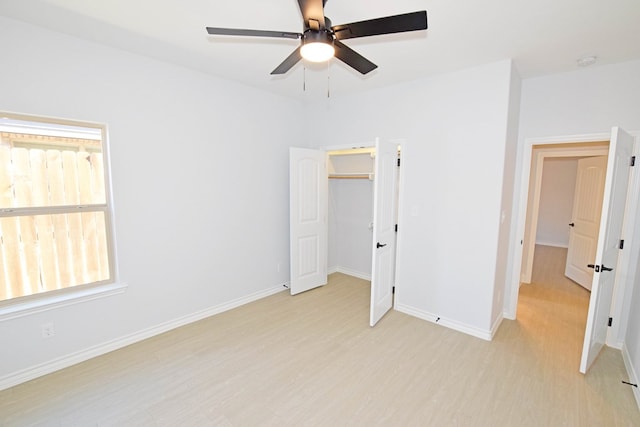 unfurnished bedroom with ceiling fan, a closet, and light wood-type flooring